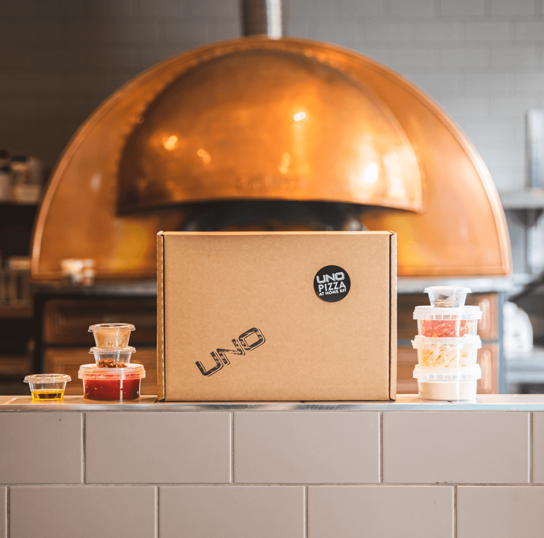 pizza kit content in front of the pizza oven