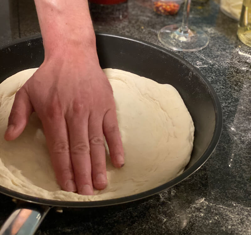 pizza base on frying pan