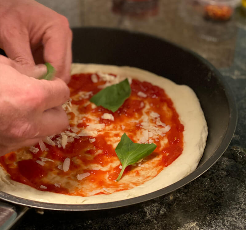 adding pizza toppings