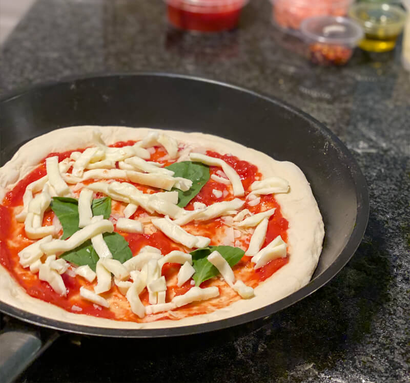 adding pizza toppings